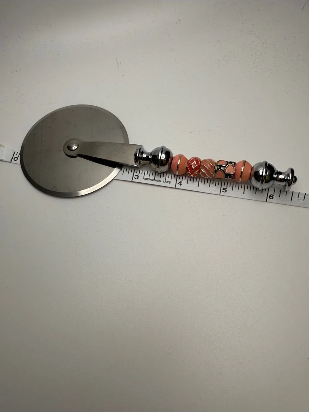 Decorative Coral-Peach Beaded Pizza Cutter with Chrome Handle